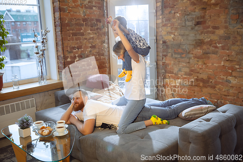 Image of Mother, father and son at home having fun, comfort and cozy concept