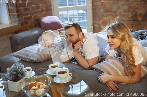 Image of Mother, father and son at home having fun, comfort and cozy concept