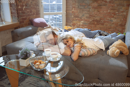 Image of Mother, father and son at home having fun, comfort and cozy concept