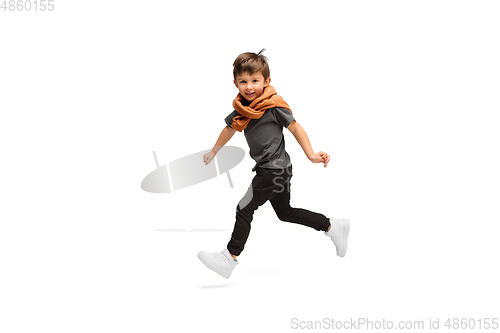 Image of Happy caucasian little boy isolated on white studio background. Looks happy, cheerful, sincere. Copyspace. Childhood, education, emotions concept