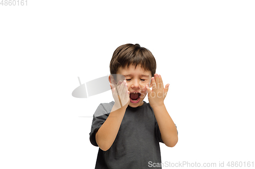 Image of Happy caucasian little boy isolated on white studio background. Looks happy, cheerful, sincere. Copyspace. Childhood, education, emotions concept