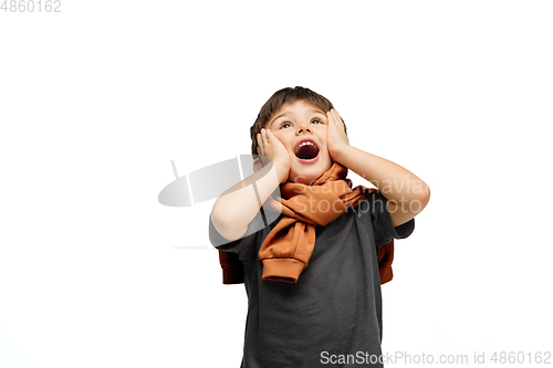 Image of Happy caucasian little boy isolated on white studio background. Looks happy, cheerful, sincere. Copyspace. Childhood, education, emotions concept