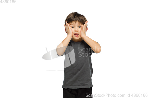 Image of Happy caucasian little boy isolated on white studio background. Looks happy, cheerful, sincere. Copyspace. Childhood, education, emotions concept