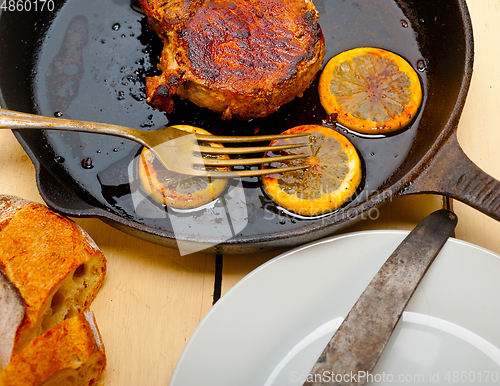 Image of pork chop seared on iron skillet