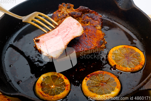 Image of pork chop seared on iron skillet