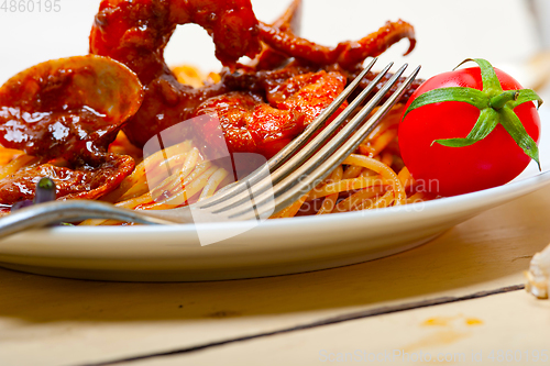 Image of Italian seafood spaghetti pasta on red tomato sauce