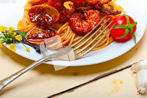 Image of Italian seafood spaghetti pasta on red tomato sauce