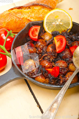 Image of Baby cuttle fish roasted on iron skillet