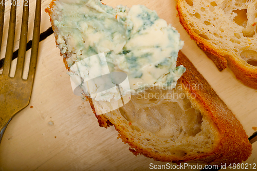 Image of fresh blue cheese spread ove french baguette