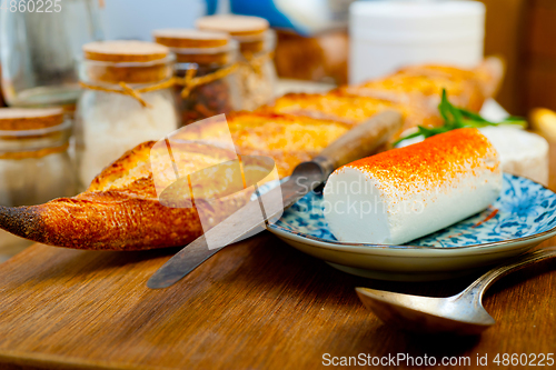 Image of French cheese and fresh  baguette on a wood cutter