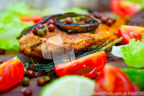 Image of wood fired hoven cooked chicken breast on wood board