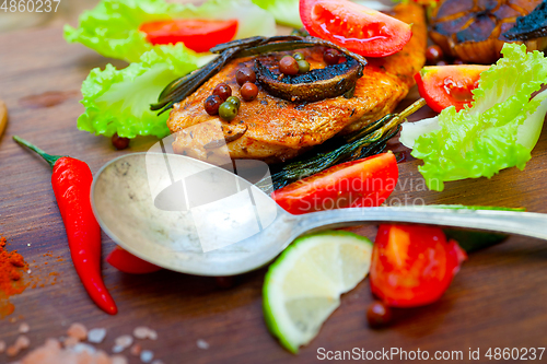 Image of wood fired hoven cooked chicken breast on wood board