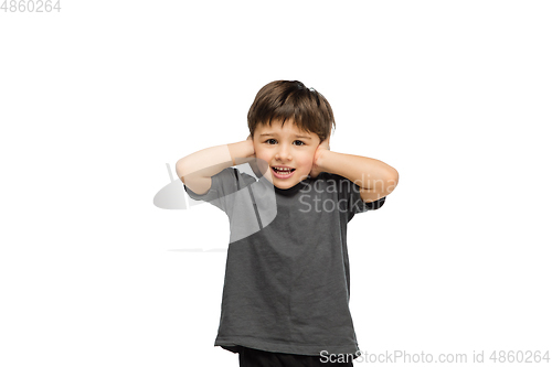 Image of Happy caucasian little boy isolated on white studio background. Looks happy, cheerful, sincere. Copyspace. Childhood, education, emotions concept