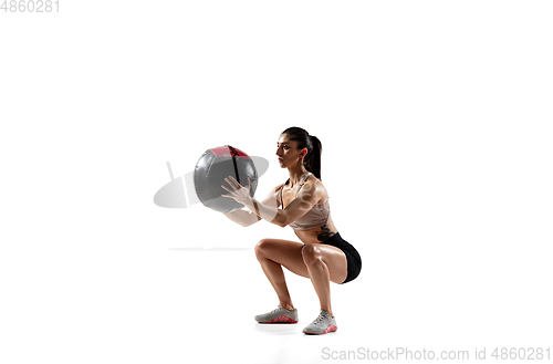 Image of Caucasian professional female athlete training isolated on white studio background. Muscular, sportive woman.