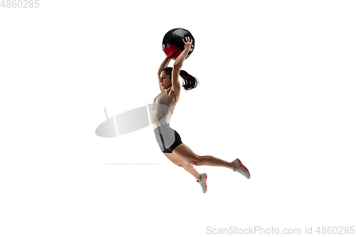 Image of Caucasian professional female athlete training isolated on white studio background. Muscular, sportive woman.