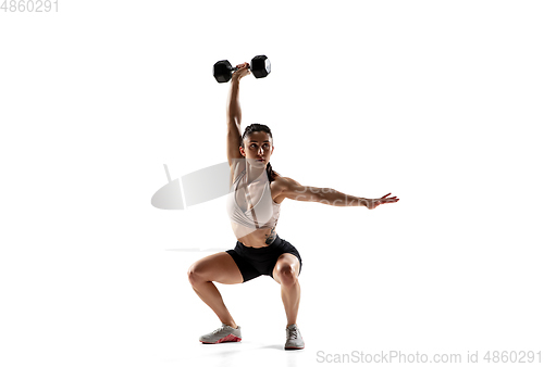 Image of Caucasian professional female athlete training isolated on white studio background. Muscular, sportive woman.