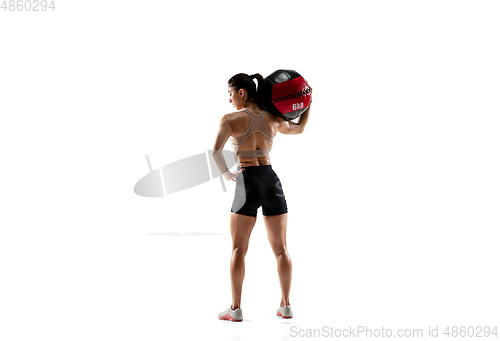 Image of Caucasian professional female athlete training isolated on white studio background. Muscular, sportive woman.