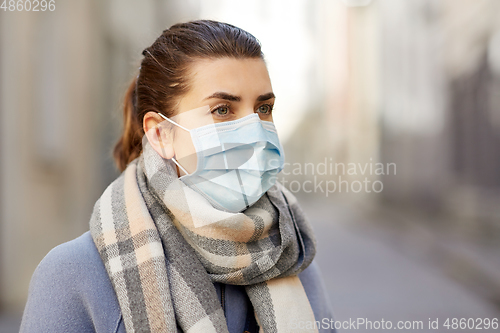 Image of young woman wearing protective medical mask