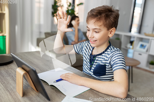 Image of boy having video calll on tablet pc at home