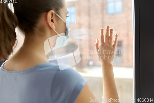 Image of sick young woman wearing protective medical mask