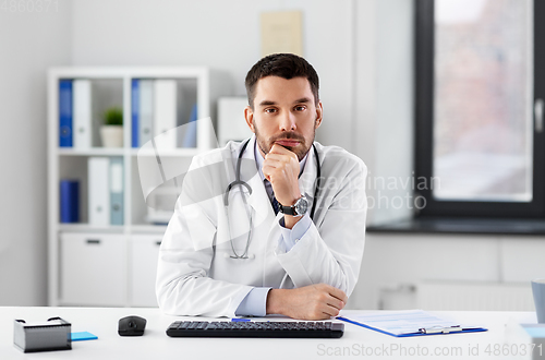 Image of thinking male doctor with stethoscope at hospital
