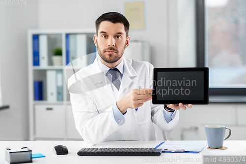 Image of doctor with tablet pc having video call at clinic