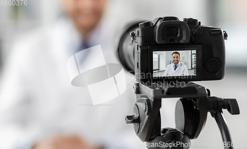 Image of male doctor recording video blog at hospital