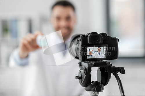 Image of doctor with drug recording video blog at hospital