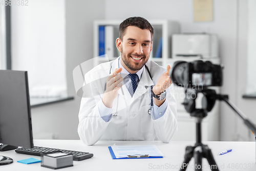 Image of male doctor recording video blog at hospital