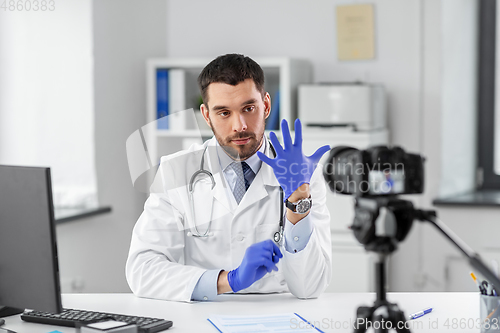 Image of male doctor with gloves recording video blog