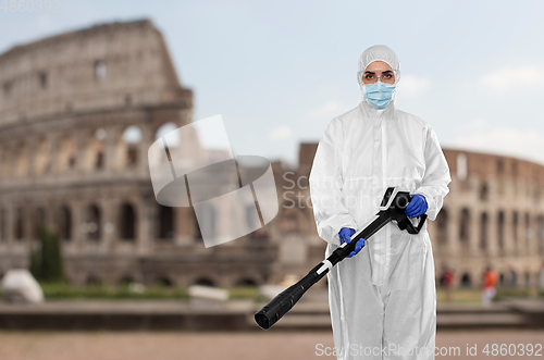 Image of sanitation worker in hazmat with pressure washer