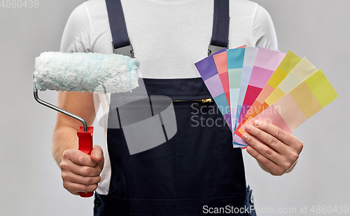 Image of close up of painter with roller and color charts