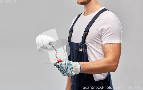 Image of close up of painter or builder with paint roller