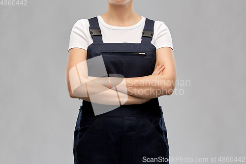 Image of close up of female painter or builder in overall