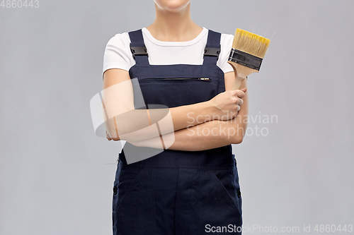 Image of close up of painter or builder with paint brush