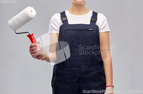 Image of close up of painter or builder with paint roller