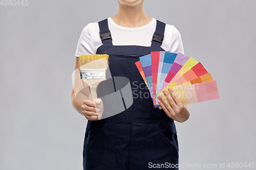 Image of close up of painter with brush and color charts