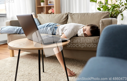 Image of sick bored woman with laptop lying on sofa at home