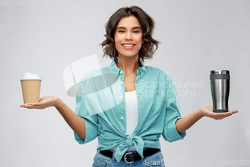 Image of woman comparing thermo cup and paper coffee cup