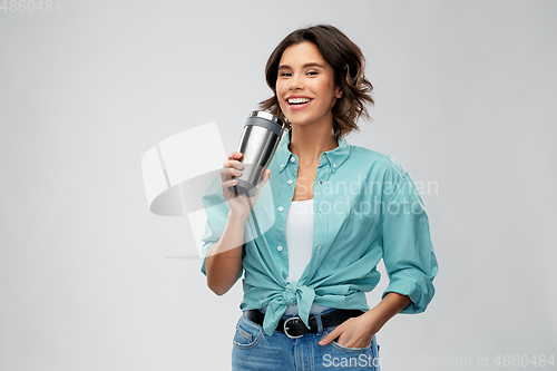 Image of woman with thermo cup or tumbler for hot drinks