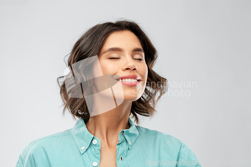 Image of portrait of smiling young woman breathing