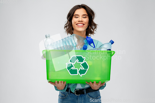 Image of smiling young woman sorting plastic waste