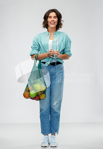 Image of woman with bag for food shopping and glass bottle