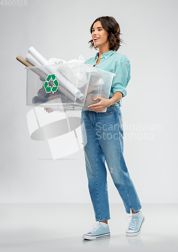 Image of happy smiling young woman sorting paper waste
