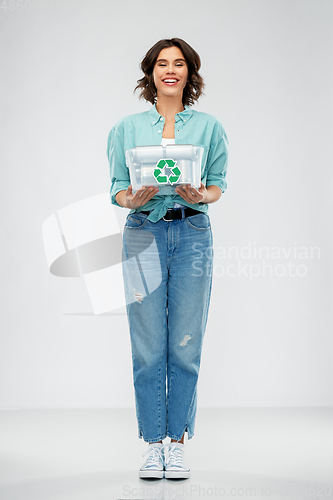 Image of smiling young woman sorting metallic waste