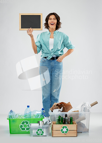 Image of happy woman sorting paper, metal and plastic waste