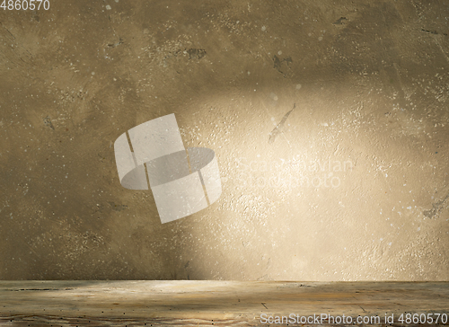 Image of beige wall and wooden shelf