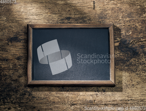 Image of blackboard frame on wooden table