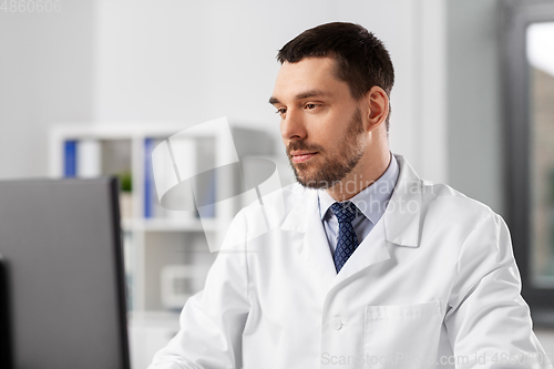 Image of male doctor with computer working at hospital
