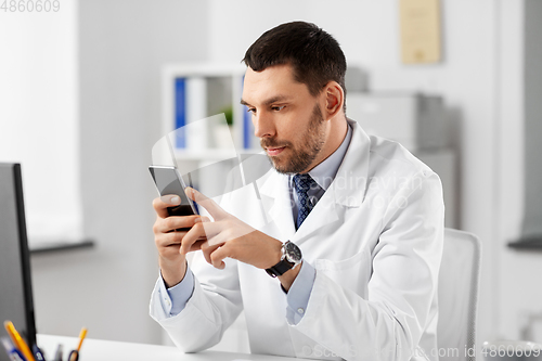 Image of male doctor with smartphone at hospital